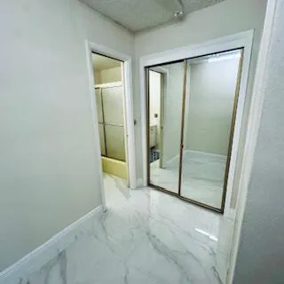 an empty room with sliding glass door and shower