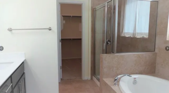 a bathroom with a tub and shower