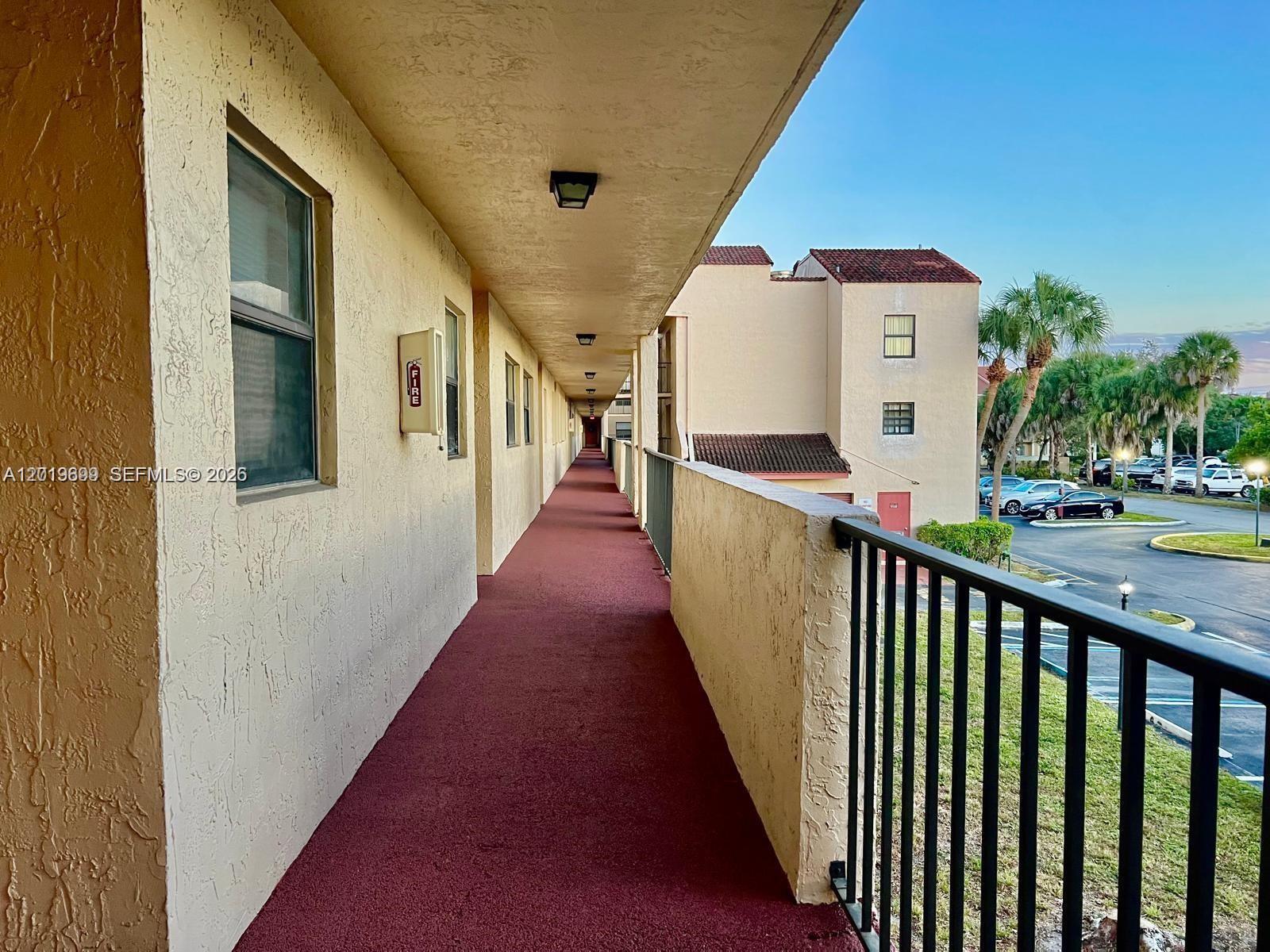 3470 Foxcroft Road, Unit 204 Miramar, FL 33025 - Photo 36 of 40 a view of balcony with wooden floor and seating space