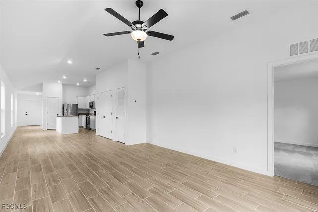 a view of kitchen with granite countertop cabinets and wooden floor
