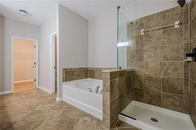 a bathroom with a bathtub and a shower