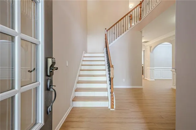 a view of staircase with white walls and railing