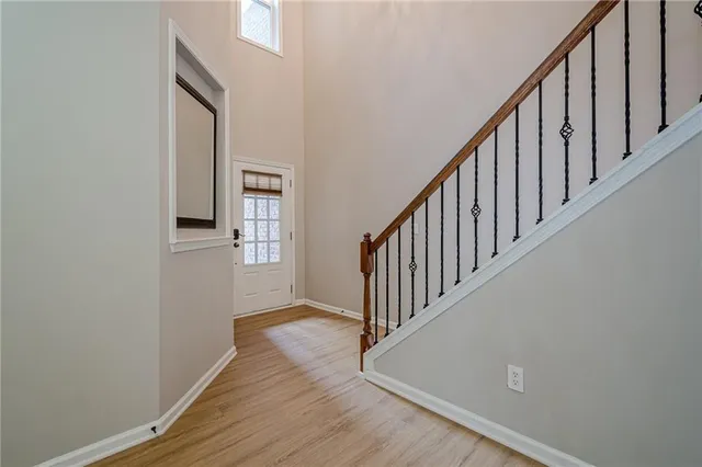 a view of a hallway with wooden floor and staircase