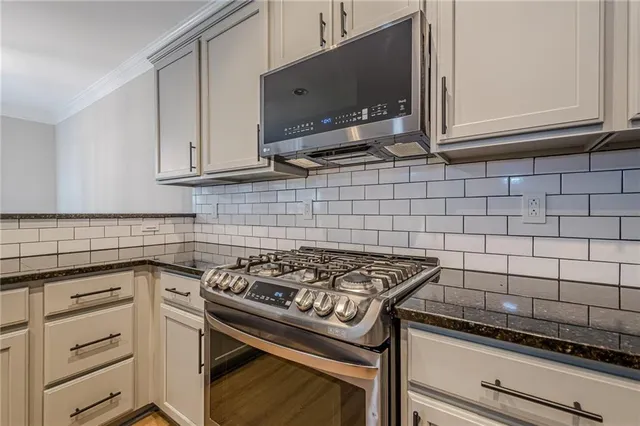 a kitchen with a stove and a microwave
