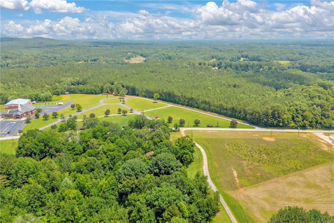 100 Newberry Road Walhalla, SC 29691 - Photo 8 of 13 Vast, verdant landscape unfolds with mature trees and open fields.