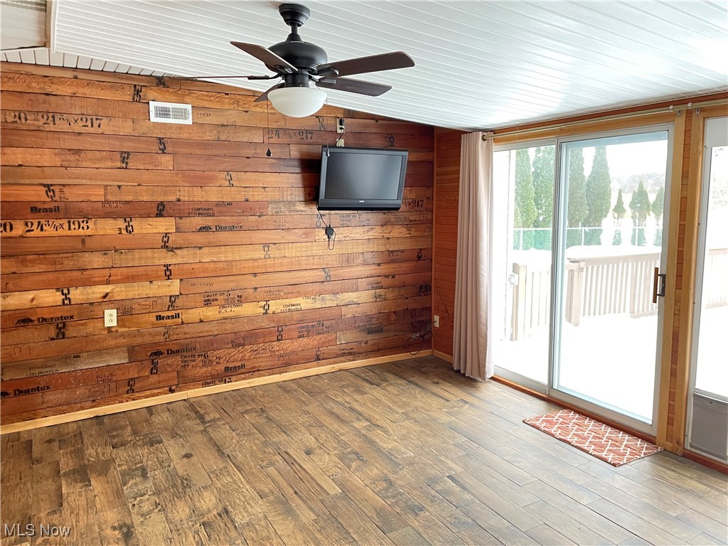 1381 Robb Road Conneaut, OH 44030 - Photo 33 of 50 Heated 3 seasons room with wood walls, wood-type flooring, and ceiling fan