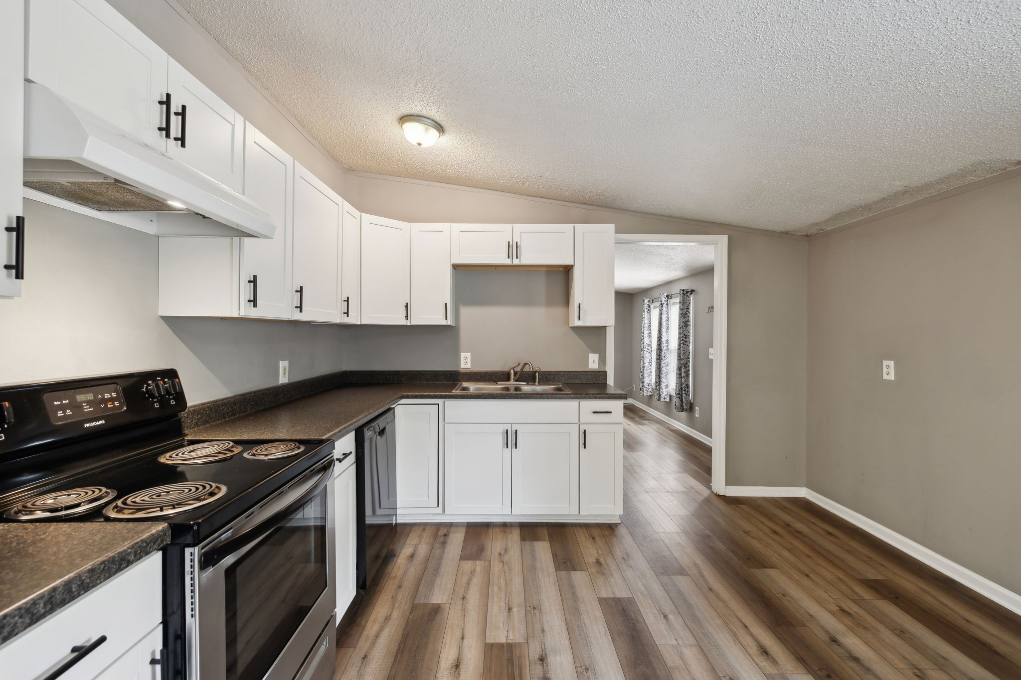2201 Mt Pleasant Cemetery Road Primm Springs, TN 38476 - Photo 12 of 36 a kitchen with granite countertop a stove sink and cabinets