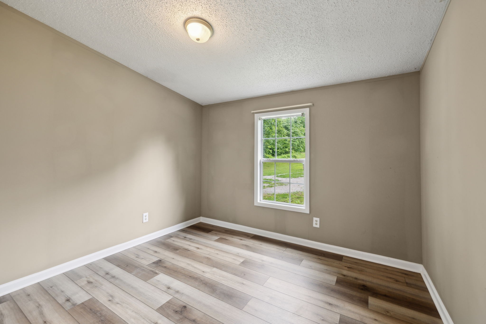 2201 Mt Pleasant Cemetery Road Primm Springs, TN 38476 - Photo 24 of 36 an empty room with wooden floor and windows