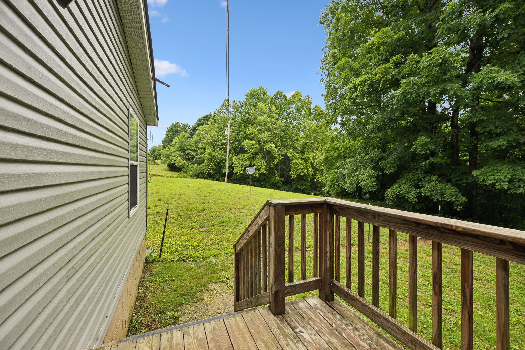 2201 Mt Pleasant Cemetery Road Primm Springs, TN 38476 - Photo 27 of 36 a view of a balcony with wooden floor and fence