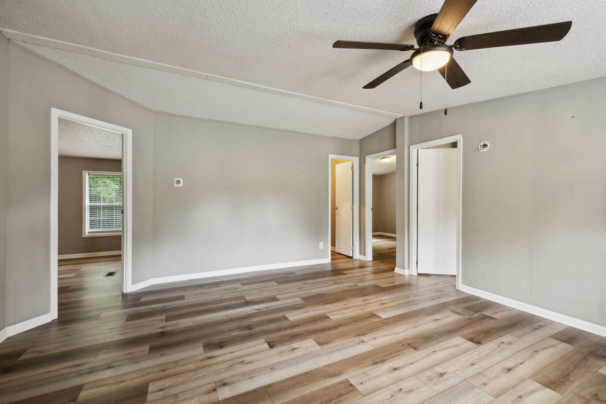 2201 Mt Pleasant Cemetery Road Primm Springs, TN 38476 - Photo 5 of 36 a view of a livingroom with a ceiling fan wooden floor and a ceiling fan