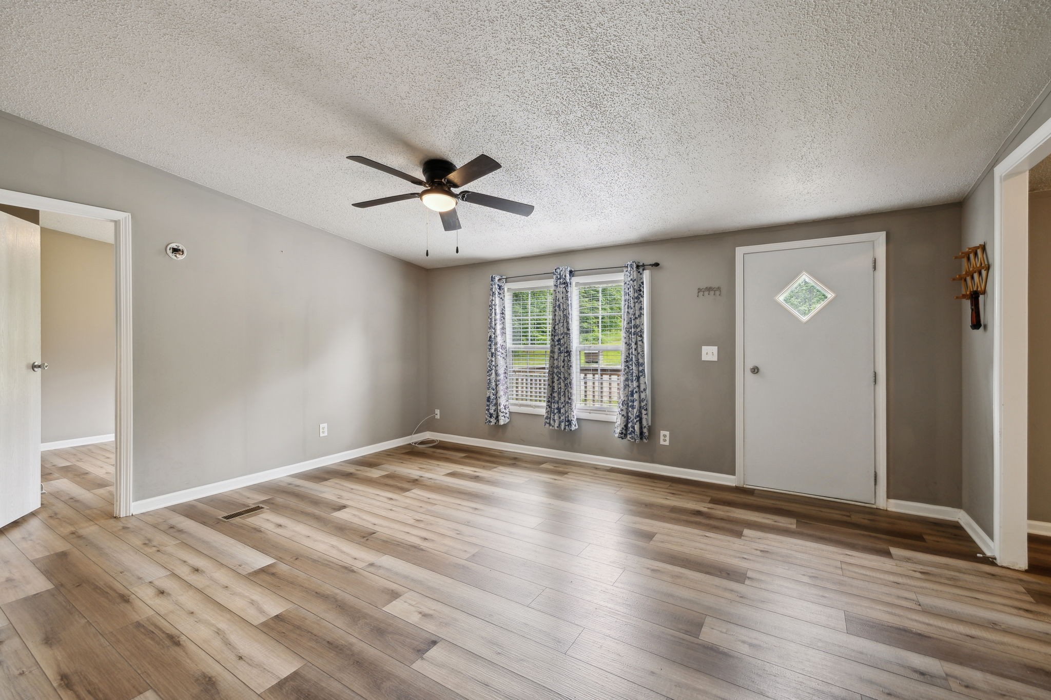 2201 Mt Pleasant Cemetery Road Primm Springs, TN 38476 - Photo 9 of 36 a view of an empty room with a window and wooden floor