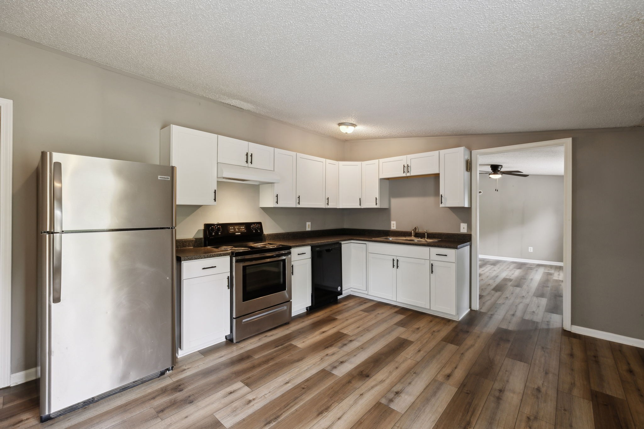 2201 Mt Pleasant Cemetery Road Primm Springs, TN 38476 - Photo 10 of 36 a kitchen with a refrigerator a stove top oven and white walls