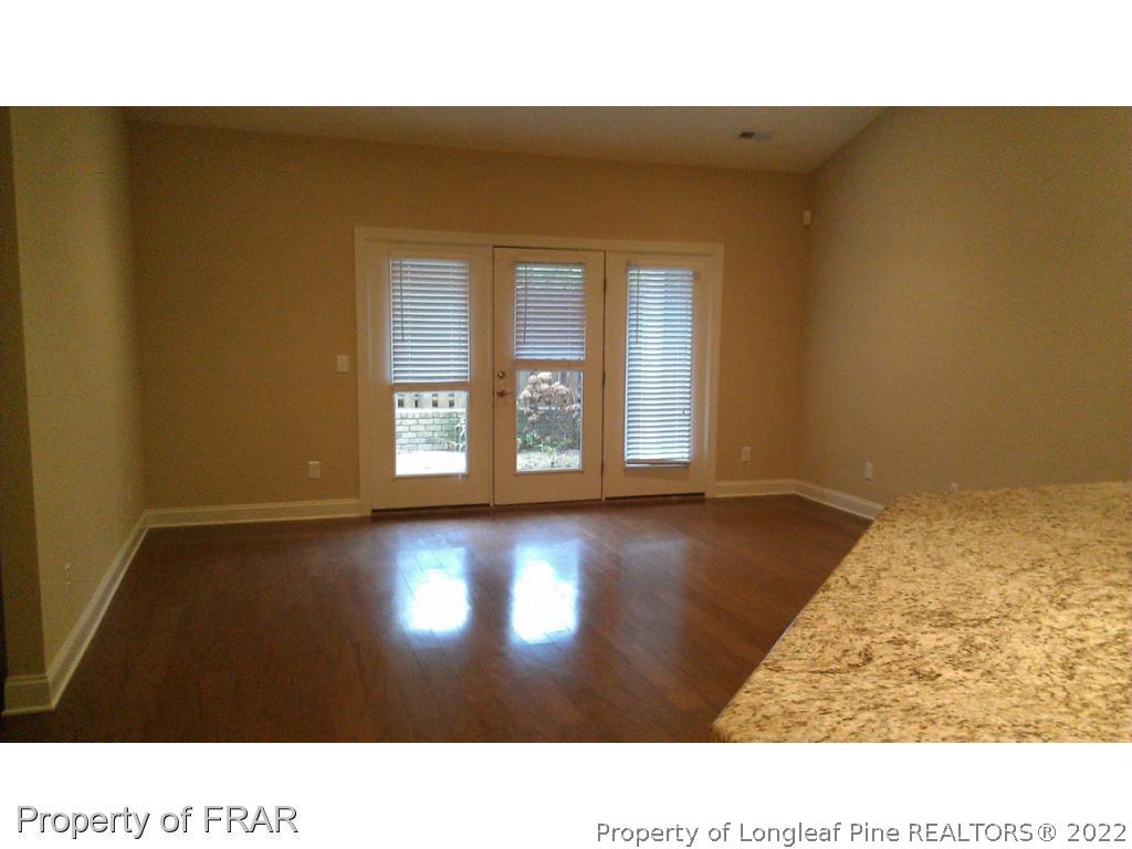 8 Elk Ridge Lane Southern Pines, NC 28387 - Photo 3 of 15 a open hall with a floor to ceiling window and wooden floor