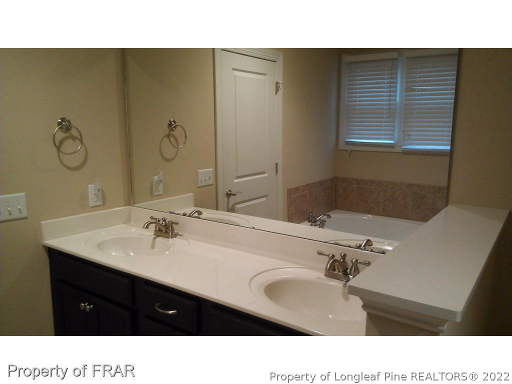 8 Elk Ridge Lane Southern Pines, NC 28387 - Photo 8 of 15 a bathroom with a sink double vanity and a mirror