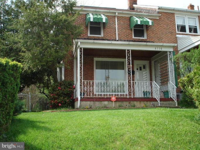 6110 Dunroming Road Baltimore, MD 21239 - Photo 1 of 11 front view of a house with a yard