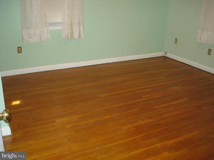 6110 Dunroming Road Baltimore, MD 21239 - Photo 8 of 11 a view of a room with wooden floor and a window