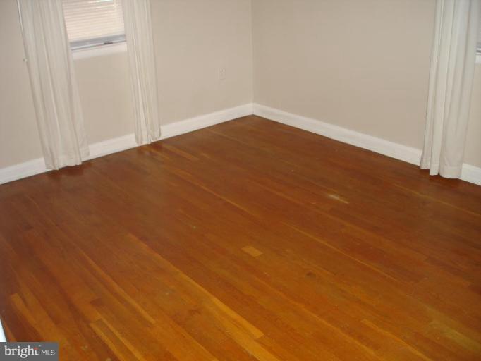 6110 Dunroming Road Baltimore, MD 21239 - Photo 9 of 11 a view of empty room with wooden floor