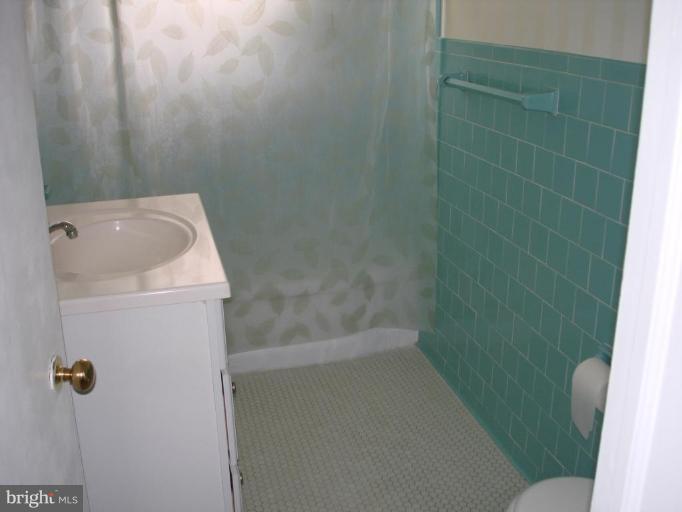 6110 Dunroming Road Baltimore, MD 21239 - Photo 10 of 11 a bathroom with a sink and toilet