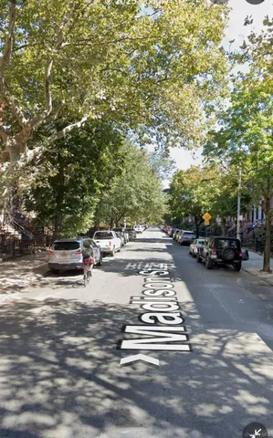 a view of street with parked cars