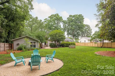 a view of a house with a yard and sitting area
