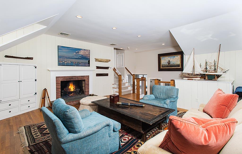 155 Michigan Road New Canaan, CT 06840 - Photo 12 of 40 a living room with furniture a flat screen tv and a fireplace