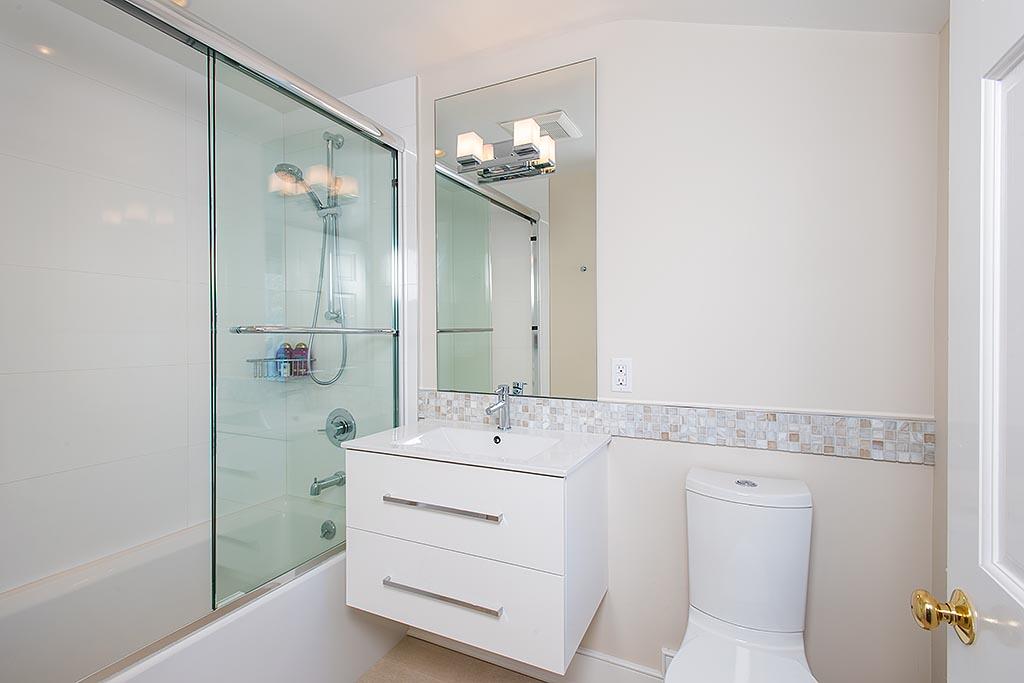 155 Michigan Road New Canaan, CT 06840 - Photo 22 of 40 a bathroom with a sink a toilet and shower