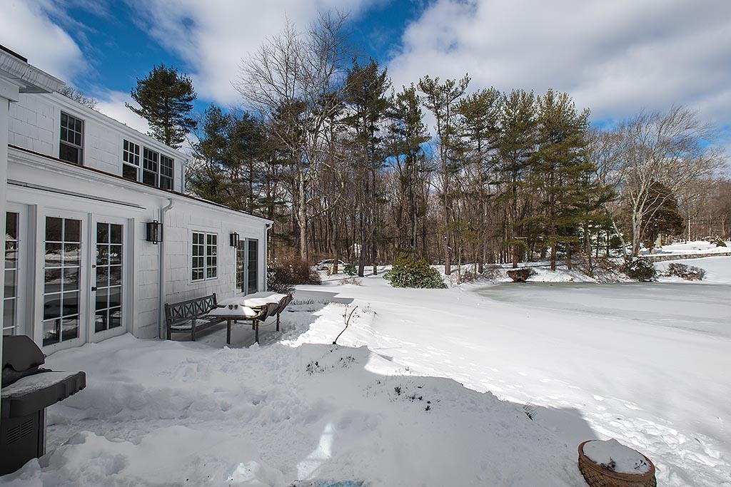 155 Michigan Road New Canaan, CT 06840 - Photo 24 of 40 a view of a ocean with a bench in the patio