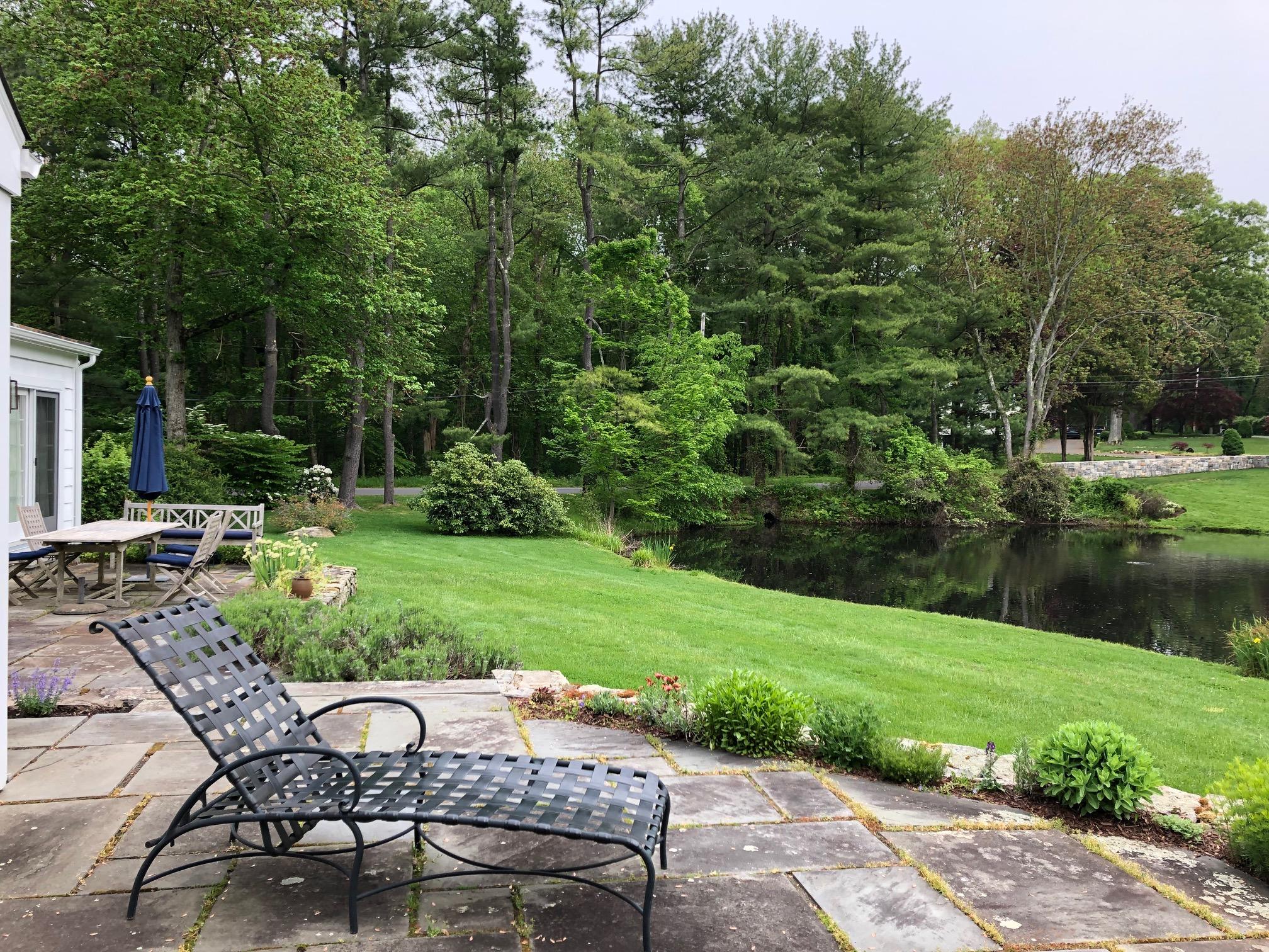 155 Michigan Road New Canaan, CT 06840 - Photo 28 of 40 a view of a chair and table on the garden