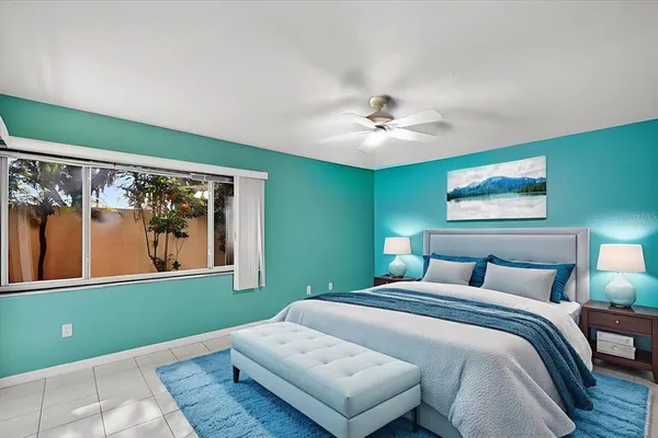 a bedroom with a large bed and a chandelier