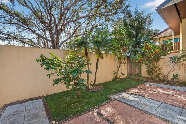 a view of a yard with plants and trees