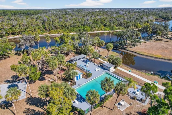 an aerial view of lake and residential houses with outdoor space
