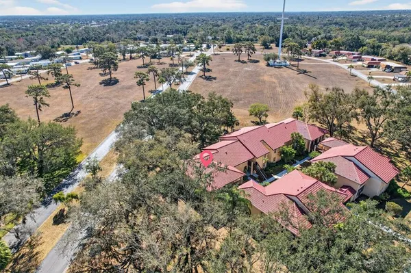 an aerial view of a house with a yard and lake view