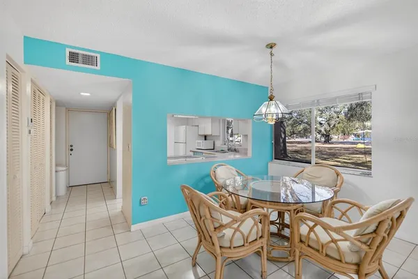 a dining room with furniture and window