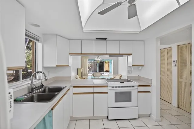 a kitchen with appliances a sink and cabinets