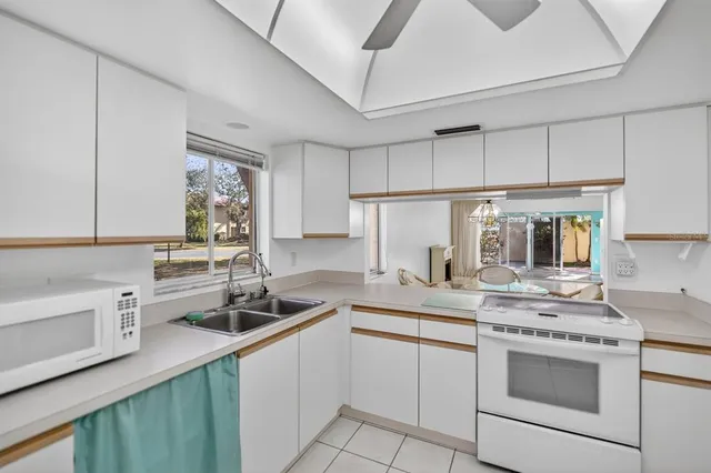 a kitchen with a sink stove and cabinets