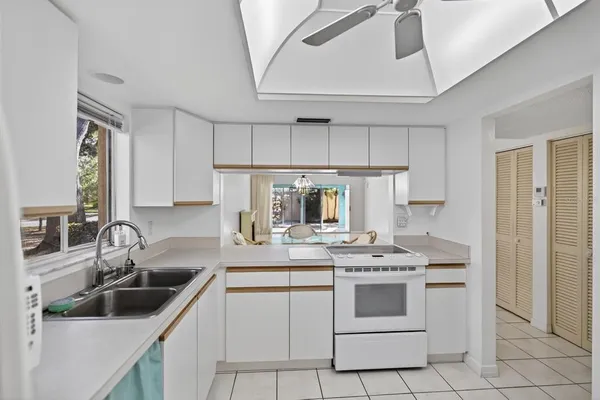 a kitchen with appliances a sink and cabinets