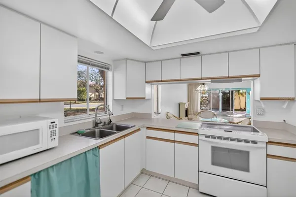 a kitchen with a sink stove and cabinets