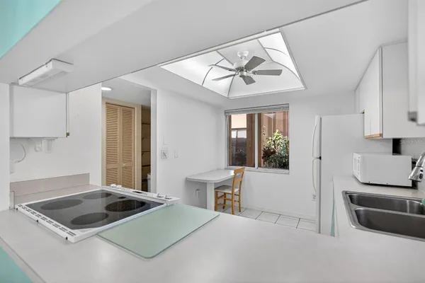 a kitchen with a stove a sink and a refrigerator