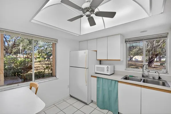 a kitchen with a refrigerator a sink and cabinets