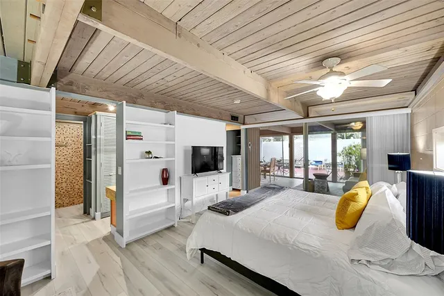 a bedroom with furniture and a chandelier