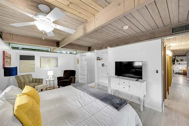 a bedroom with furniture and a flat screen tv