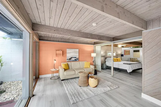 a bedroom with furniture and wooden floor