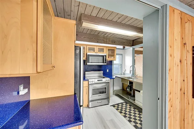 a kitchen with stainless steel appliances a stove and a refrigerator