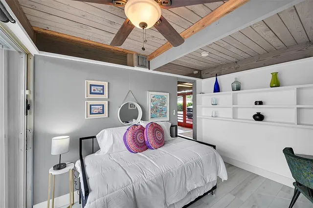 a bedroom with a bed a desk and chair