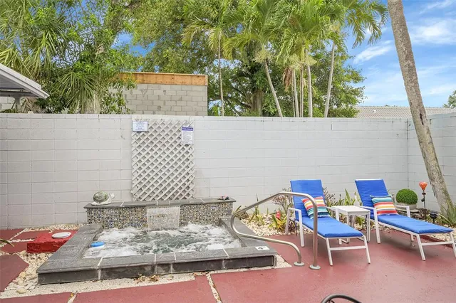 a backyard of a house with table and chairs