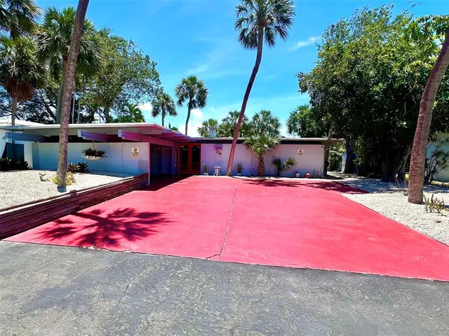 a view of a backyard with table and chairs under an umbrella