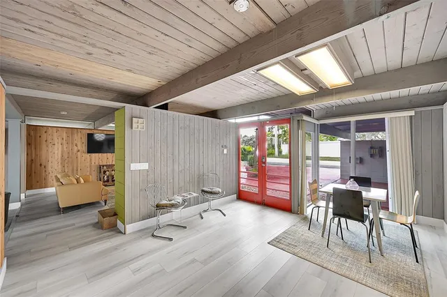 a view of a room with furniture and wooden floor