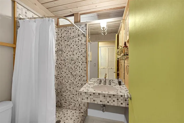 a bathroom with a shower curtain and a sink