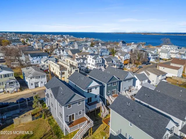 an aerial view of residential houses with city view