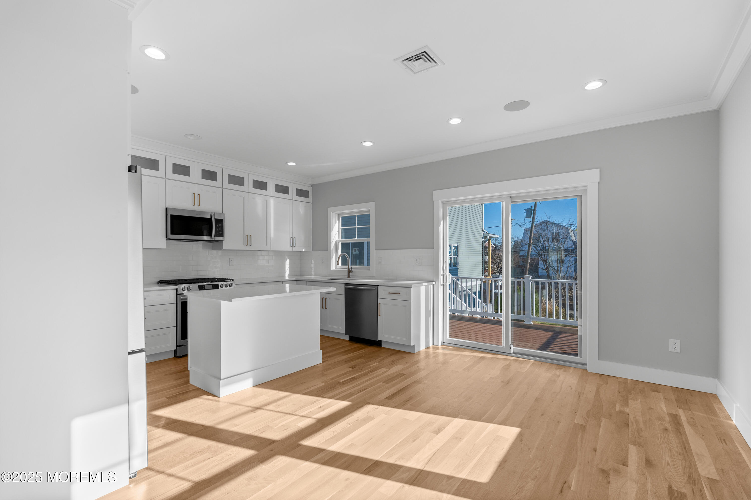 Undisclosed Address Highlands, NJ 07732 - Photo 3 of 17 a kitchen with stainless steel appliances kitchen island granite countertop a refrigerator and a stove top oven
